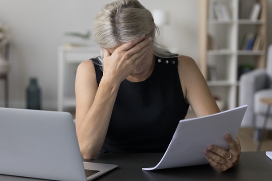 depressed-sad-mature-entrepreneur-business-woman-reading-paper-document.jpg540x360